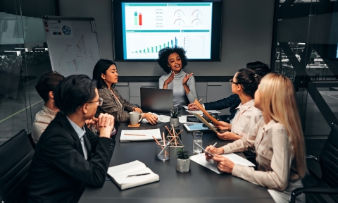 Young confident successful business people discuss and analyze work, statistics, plans, startup in a meeting room. Teamwork. Presentation.