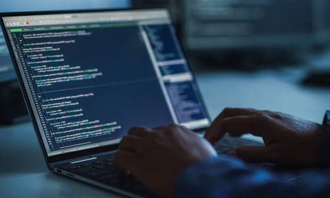 Close-up Focus on Person's Hands Typing on the Desktop Computer Keyboard. Screens Show Coding Language User Interface. Software Engineer Create Innovative e-Commerce App. Program Development