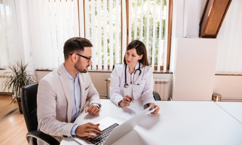 Female doctor discussing with manager.