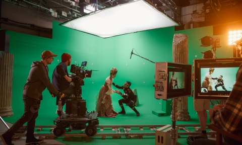 On Big Film Studio Professional Crew Shooting History Costume Drama Movie. On Set: Directing Green Screen Scene with Beautiful Lady Wearing Renaissance Costume Meets Actor Playing Monster