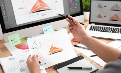 Graphic designer drawing sketches logo design.