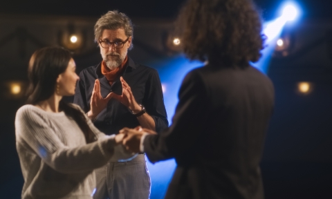 Director watching rehearsal of the play