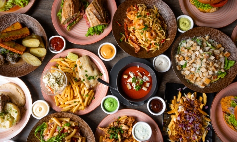 Snack, junk, fast food on table in restaurant. Soup, sauce ornament, grill hamburger, french fries, pasta with sea food