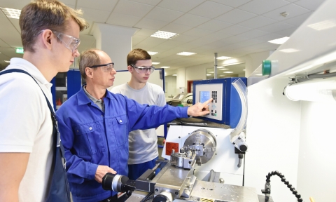 Curso de Acceso a Formación Profesional young apprentices in technical vocational training are taught by older trainers on a cnc lathes machine